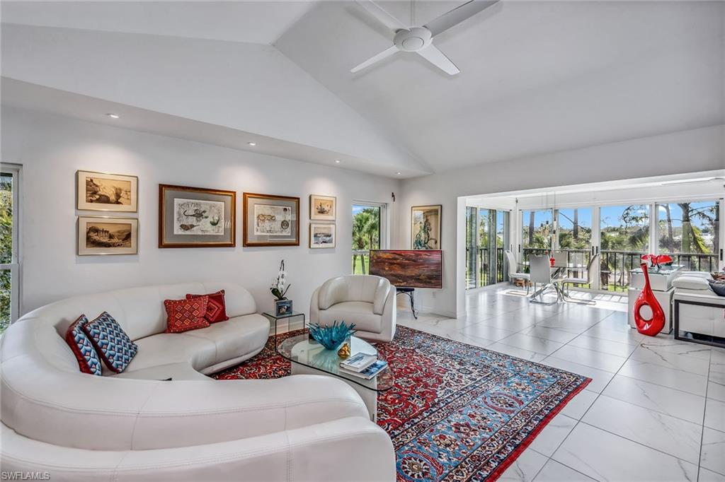 764 Eagle Creek Drive, Unit 301 Naples, FL 34113 - Photo 2 of 31 a living room with furniture and a rug