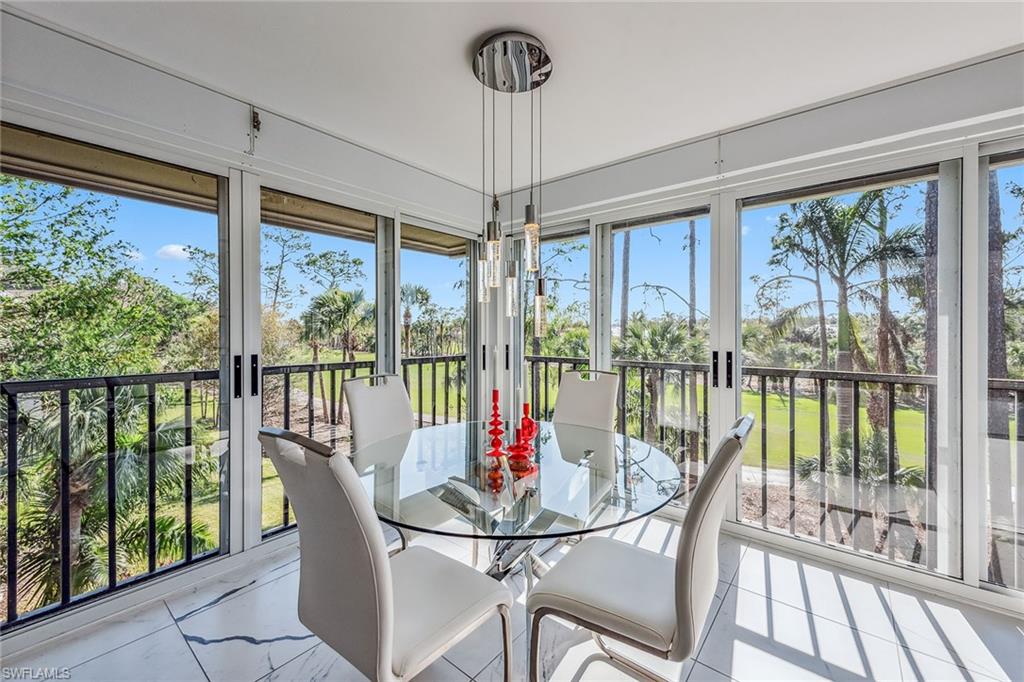 764 Eagle Creek Drive, Unit 301 Naples, FL 34113 - Photo 4 of 31 a view of a dining room with furniture water view and a floor to ceiling window