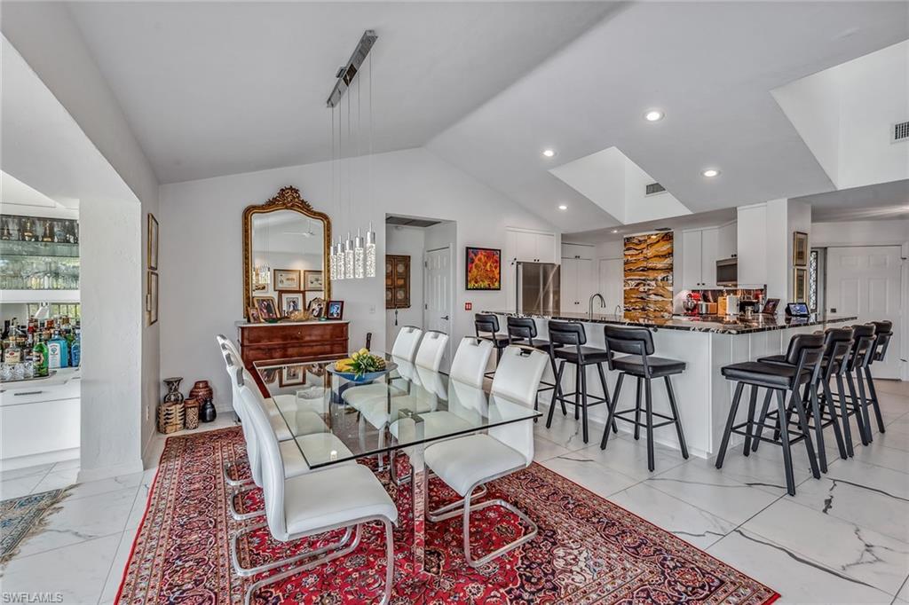 764 Eagle Creek Drive, Unit 301 Naples, FL 34113 - Photo 6 of 31 a dining room with lots of tables and chairs