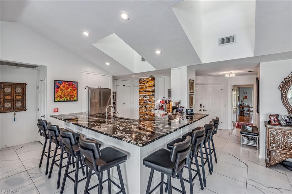 764 Eagle Creek Drive, Unit 301 Naples, FL 34113 - Photo 7 of 31 a view of a dining area with furniture