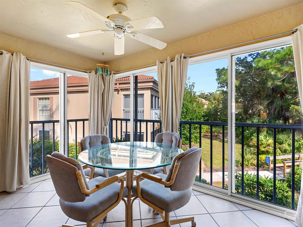 4415 Longmeadow, Unit 44 Sarasota, FL 34235 - Photo 15 of 42 a view of a dining room with furniture large windows and wooden floor