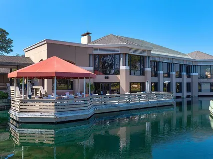 a backyard of a house with yard table and chairs