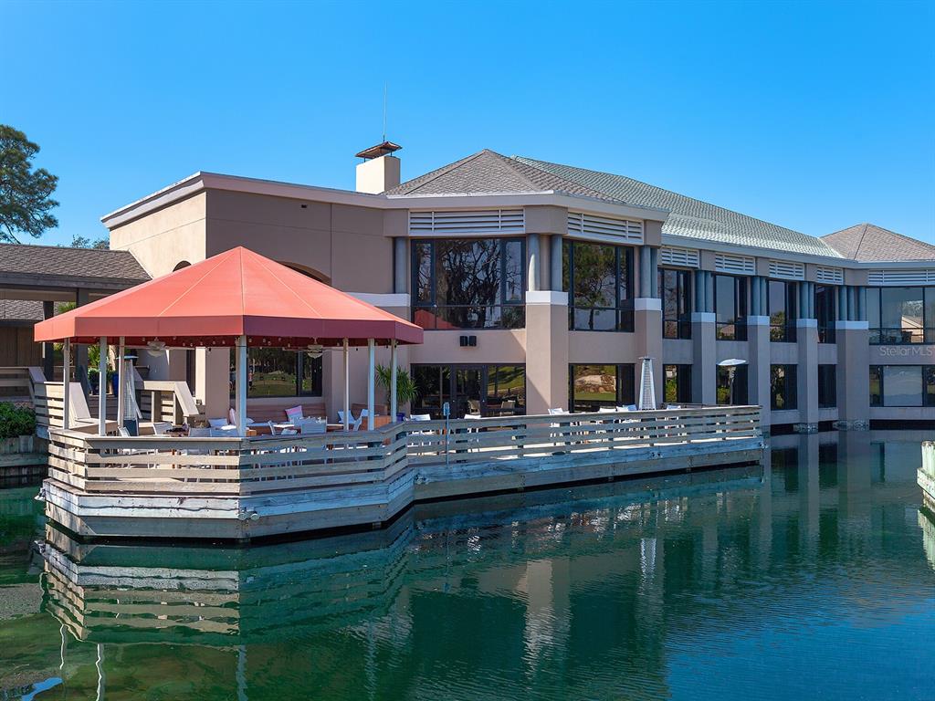 4415 Longmeadow, Unit 44 Sarasota, FL 34235 - Photo 35 of 42 a backyard of a house with yard table and chairs