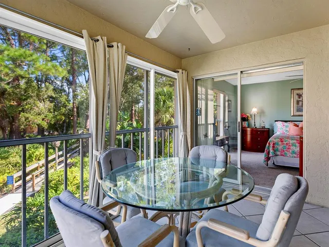 a dining room with furniture a chandelier and glass door