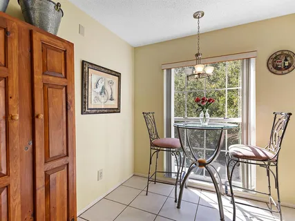 a dining room with furniture and window