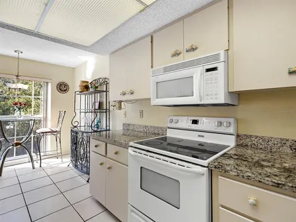a kitchen with cabinets and appliances