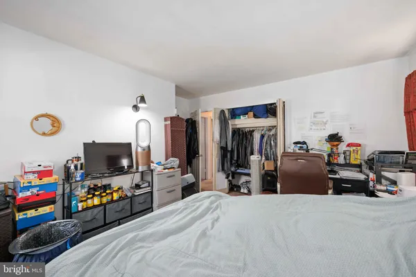 a bedroom with a bed and a flat tv screen