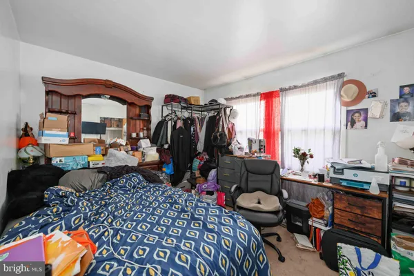 a room with furniture a rug and a window