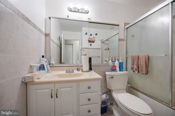 a bathroom with a sink vanity mirror and toilet