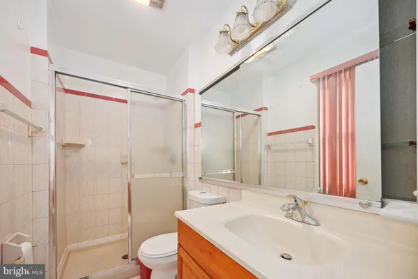 a bathroom with a sink toilet tub and shower