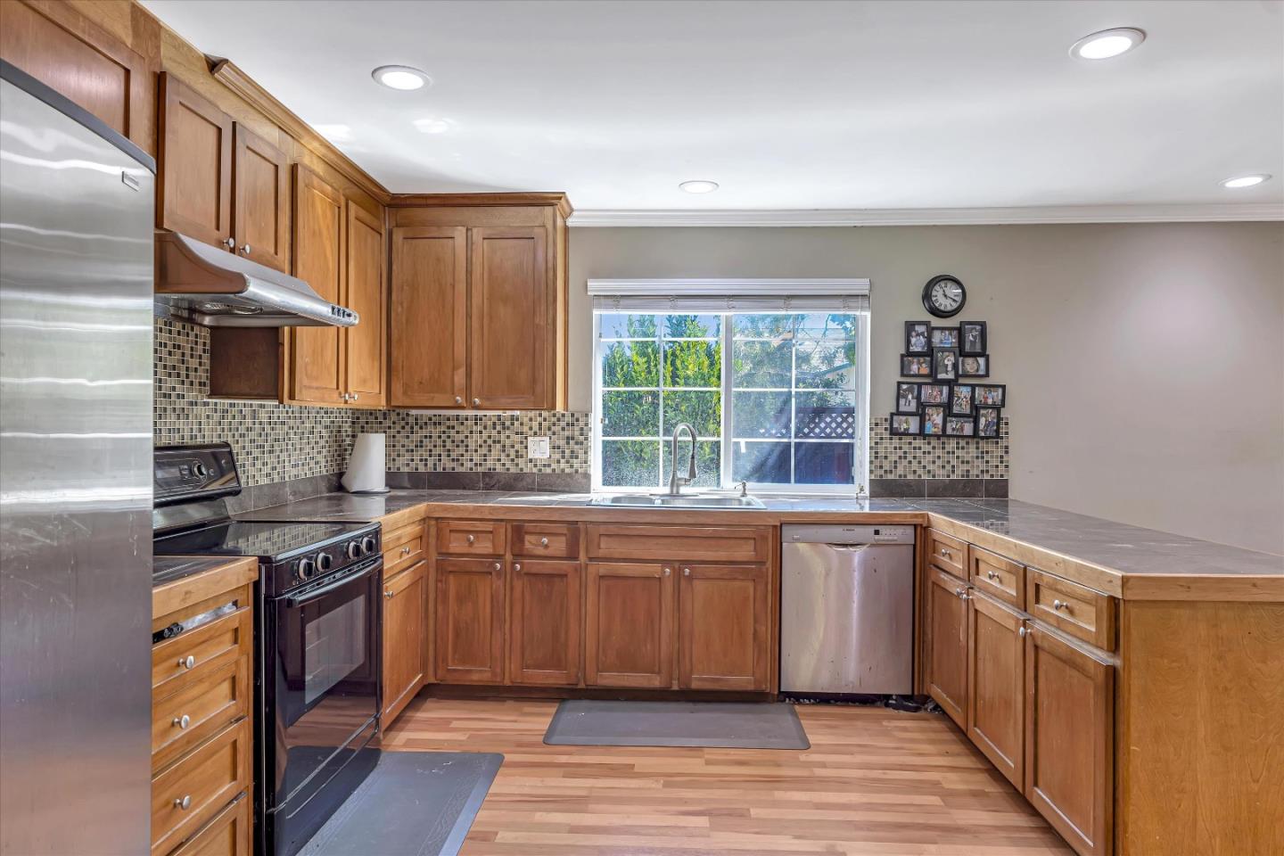 252 Sposito Circle San Jose, CA 95136 - Photo 25 of 50 a kitchen with stainless steel appliances granite countertop a stove and a sink