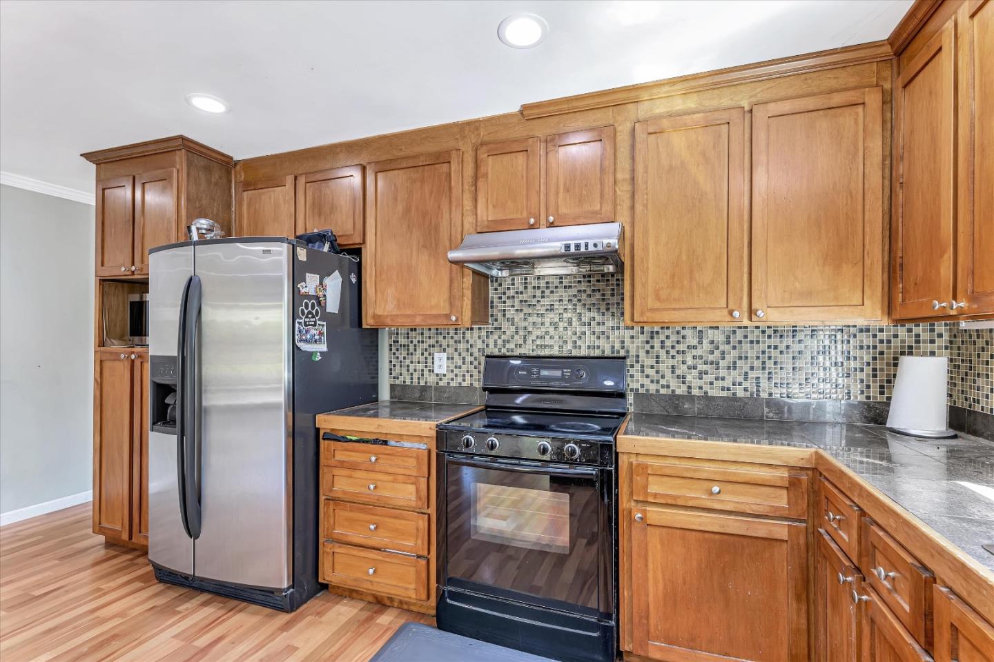 252 Sposito Circle San Jose, CA 95136 - Photo 28 of 50 a kitchen with stainless steel appliances granite countertop a refrigerator stove and sink with wooden floor