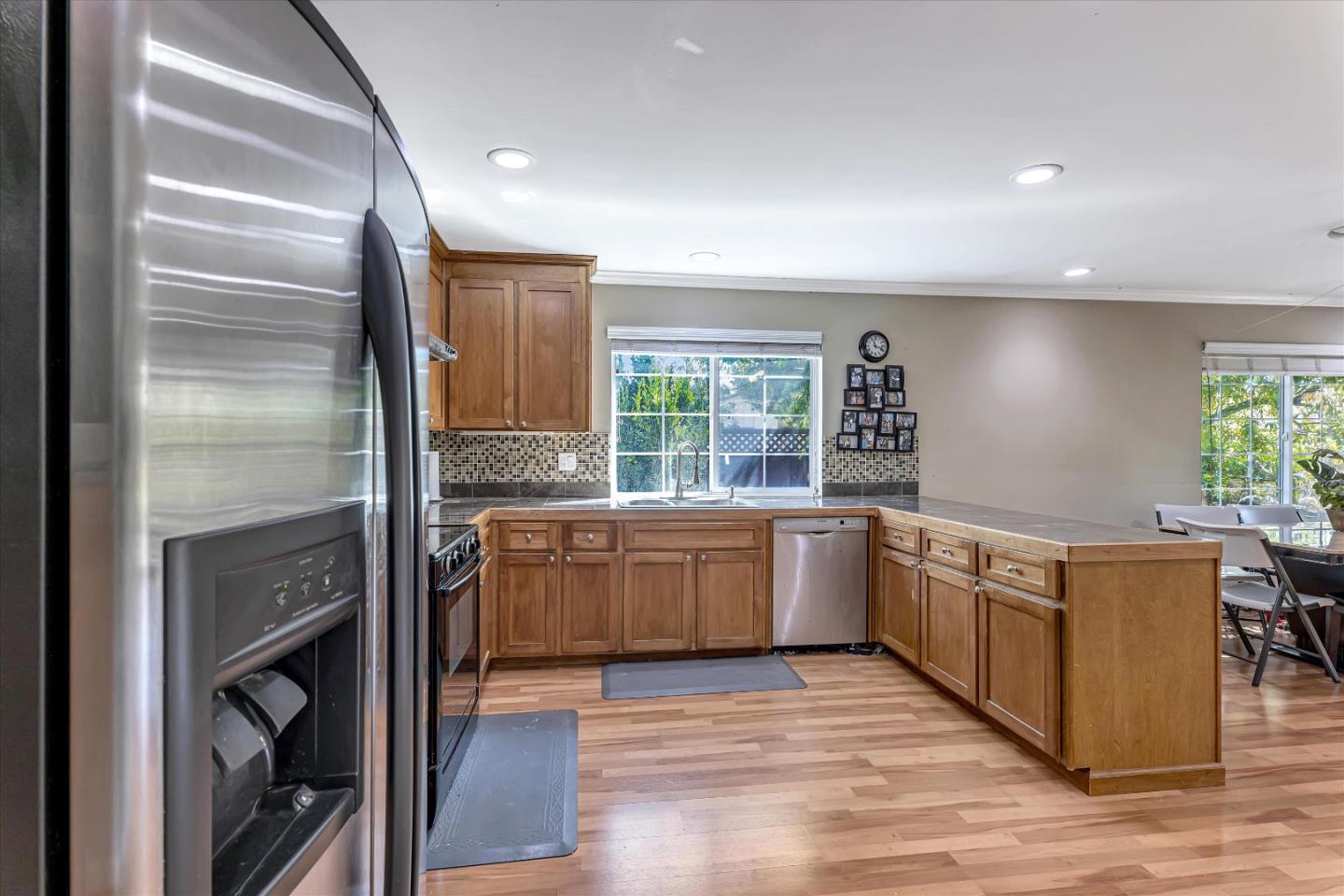252 Sposito Circle San Jose, CA 95136 - Photo 29 of 50 a kitchen with stainless steel appliances granite countertop a refrigerator a sink and wooden cabinets