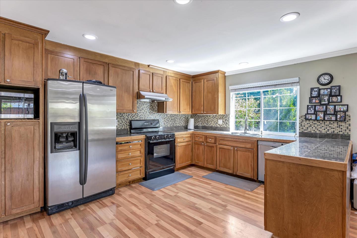 252 Sposito Circle San Jose, CA 95136 - Photo 30 of 50 a kitchen with granite countertop a refrigerator stove top oven and sink