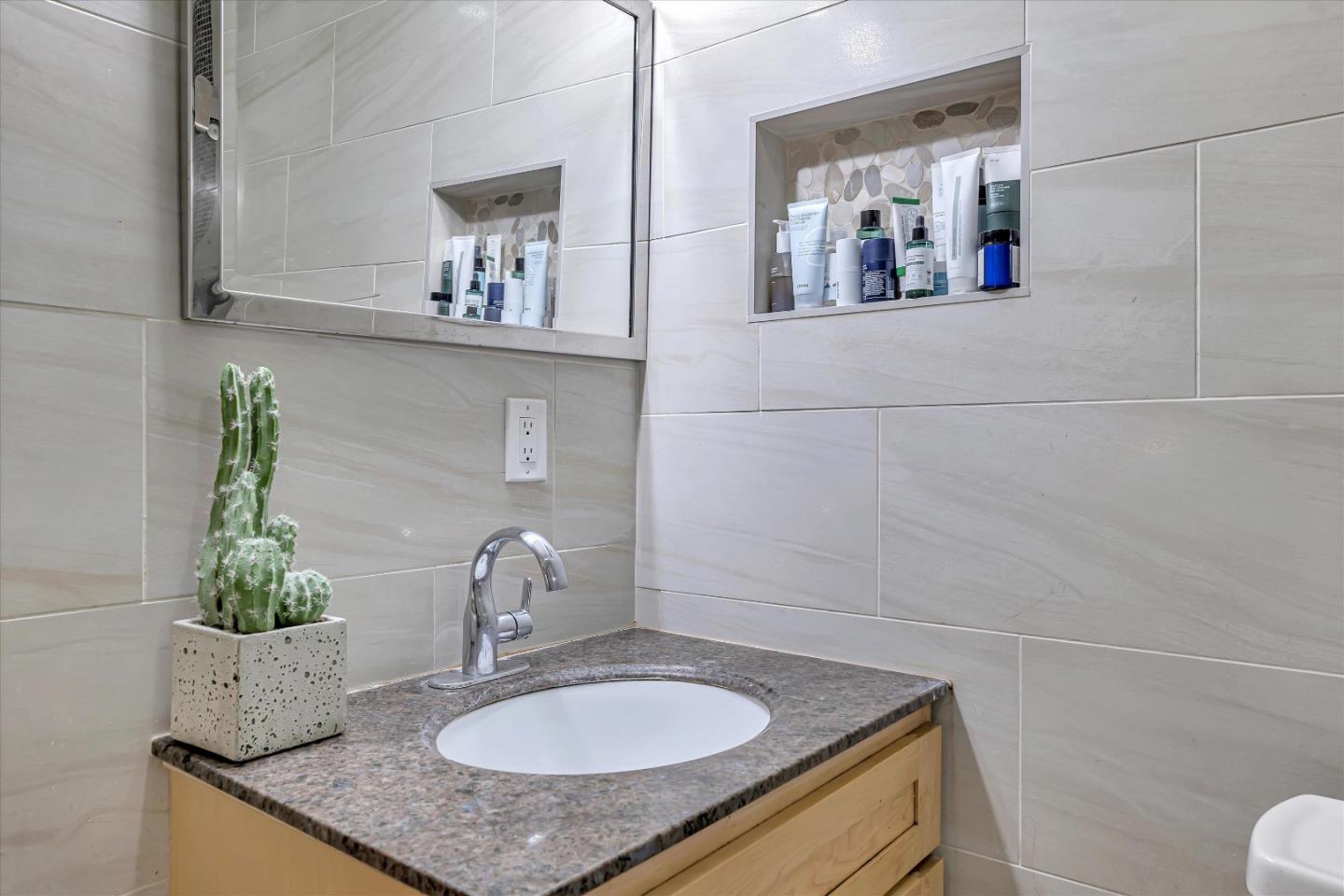 252 Sposito Circle San Jose, CA 95136 - Photo 41 of 50 a bathroom with a granite countertop sink and a mirror