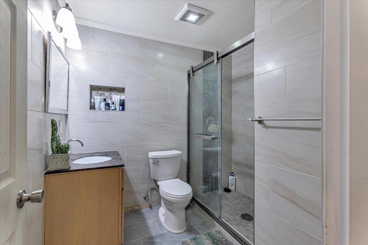 252 Sposito Circle San Jose, CA 95136 - Photo 42 of 50 a bathroom with a granite countertop toilet sink and shower