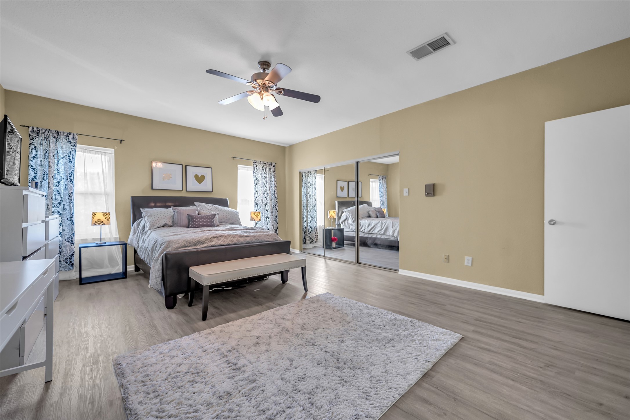 8091 El Mundo Street, Unit 8091 Houston, TX 77054 - Photo 12 of 22 a bedroom with a bed and wooden floor