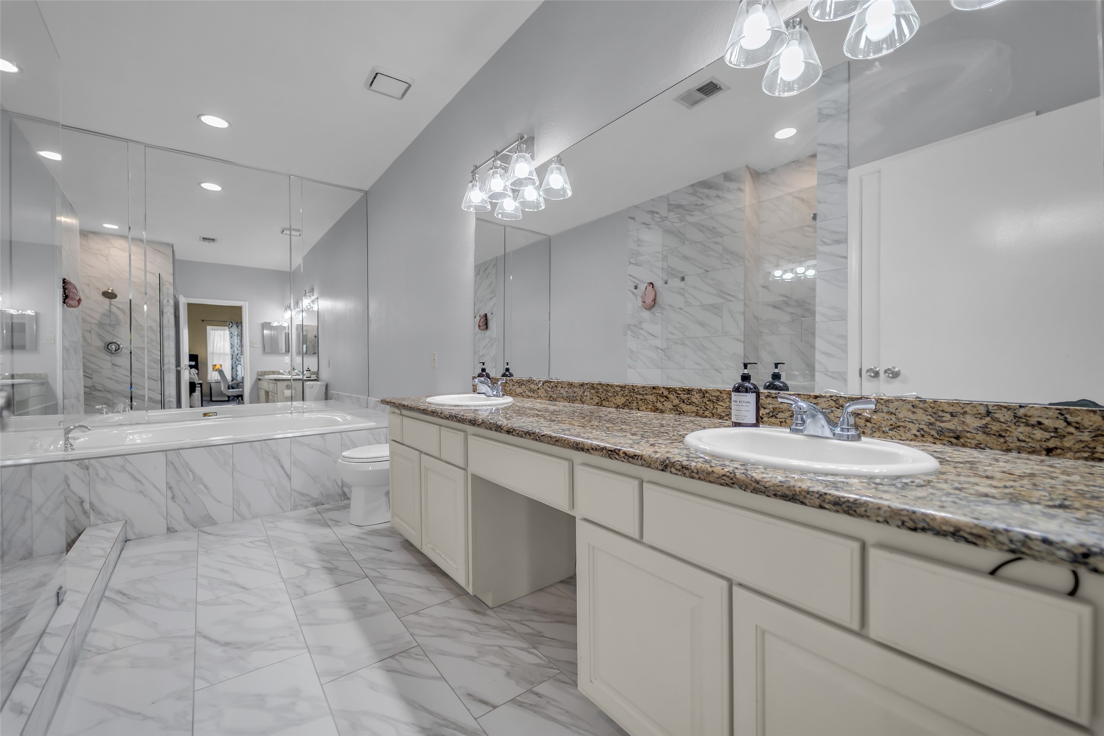 8091 El Mundo Street, Unit 8091 Houston, TX 77054 - Photo 14 of 22 a large white kitchen with a large island oven a sink stainless steel appliances and chandelier