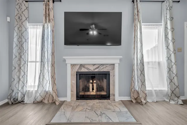 a living room with a fireplace and a floor to ceiling window