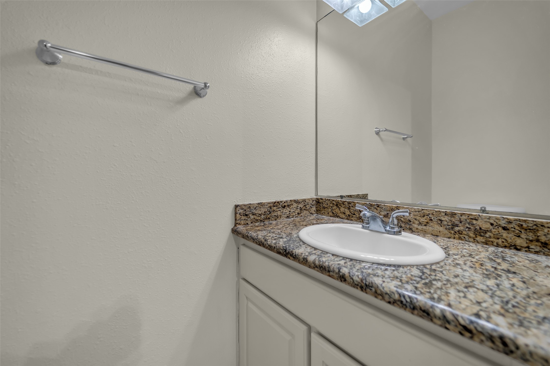 8091 El Mundo Street, Unit 8091 Houston, TX 77054 - Photo 7 of 22 a bathroom with a granite countertop sink and a mirror