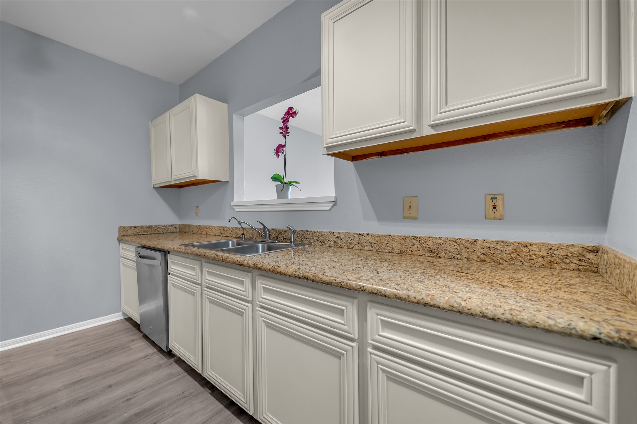 8091 El Mundo Street, Unit 8091 Houston, TX 77054 - Photo 9 of 22 a kitchen with granite countertop white cabinets and sink
