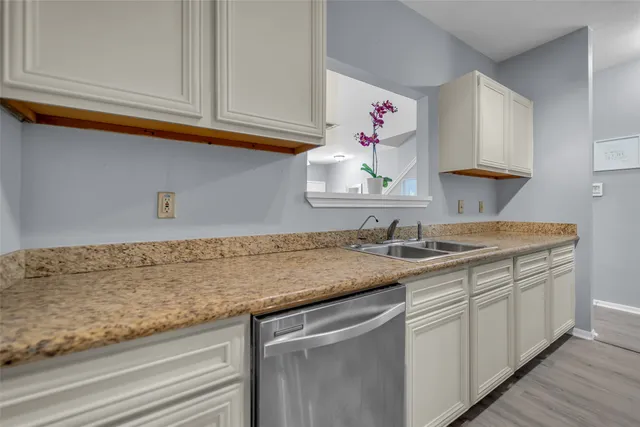 a kitchen with sink cabinets and utility