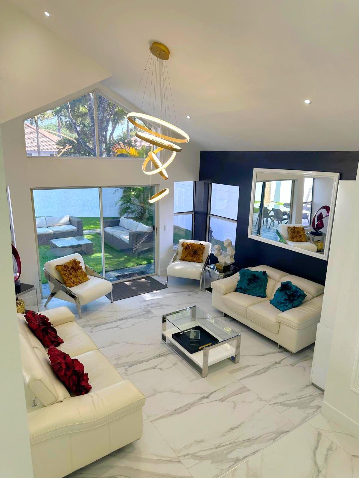 2252 Northwest 53rd Street Boca Raton, FL 33496 - Photo 14 of 23 a living room with furniture and a floor to ceiling window