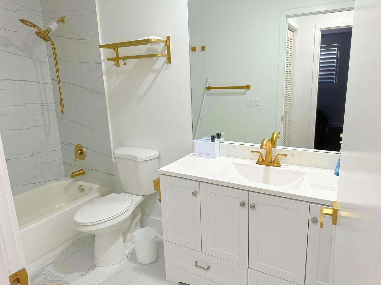 2252 Northwest 53rd Street Boca Raton, FL 33496 - Photo 16 of 23 a bathroom with a sink a toilet and shower