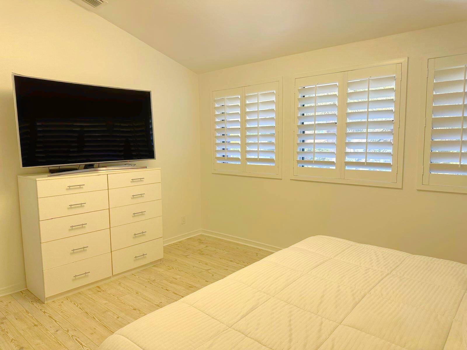 2252 Northwest 53rd Street Boca Raton, FL 33496 - Photo 22 of 23 a bedroom with a bed a flat screen tv and a window
