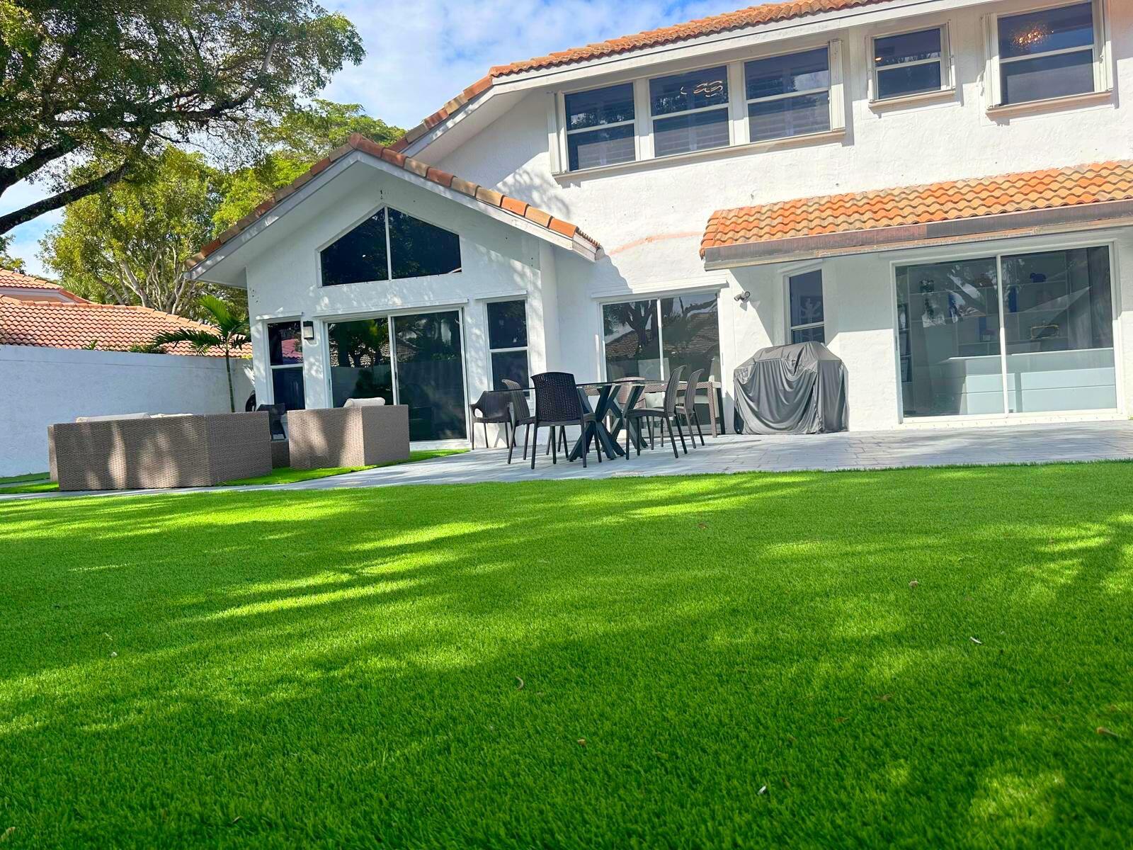 2252 Northwest 53rd Street Boca Raton, FL 33496 - Photo 4 of 23 a front view of a house with a yard table and chairs