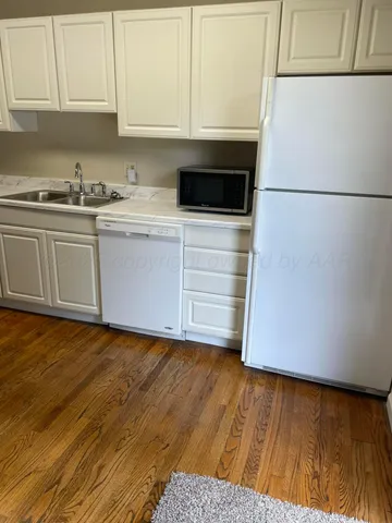 a kitchen with a sink and cabinets