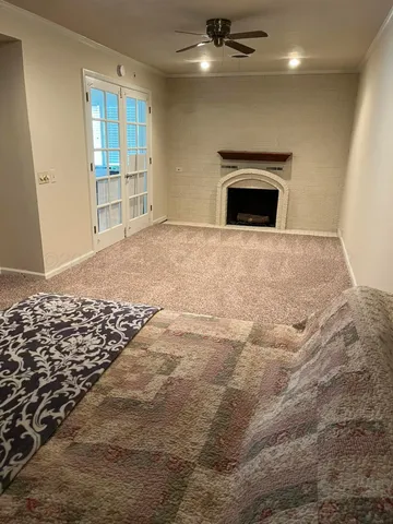 a view of an empty room with a fireplace
