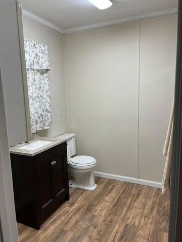a bathroom with a toilet sink and vanity