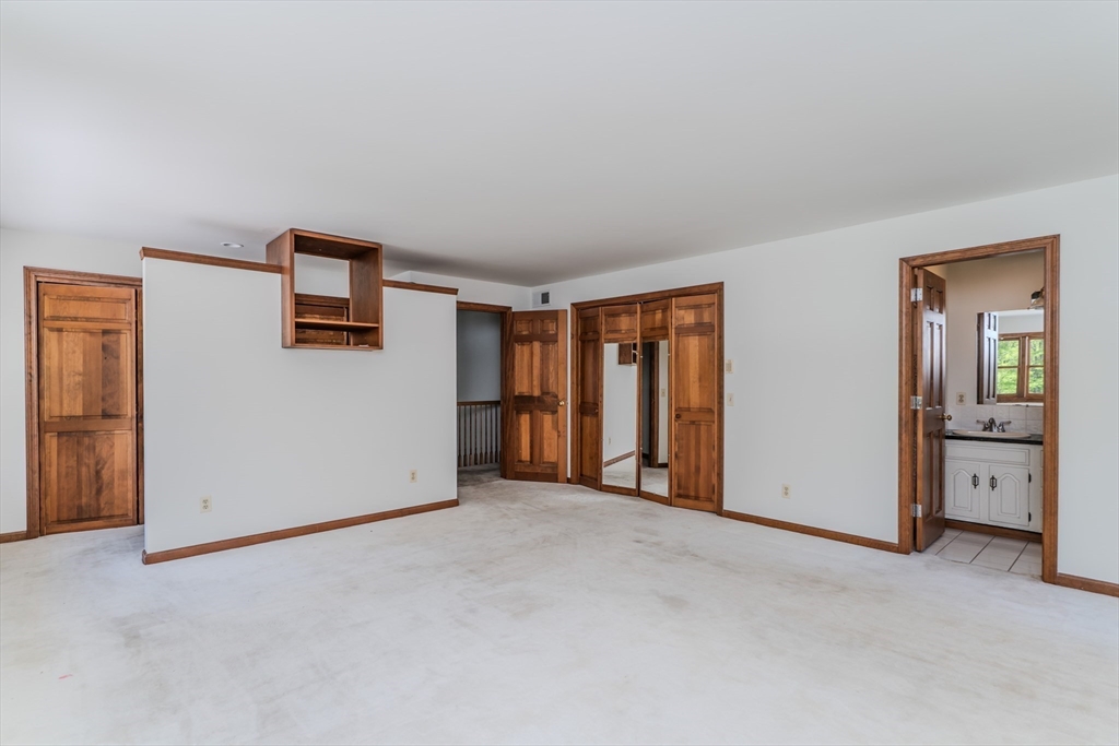 63 Larkspur Drive Amherst, MA 01002 - Photo 23 of 42 a view of an empty room with window and a kitchen