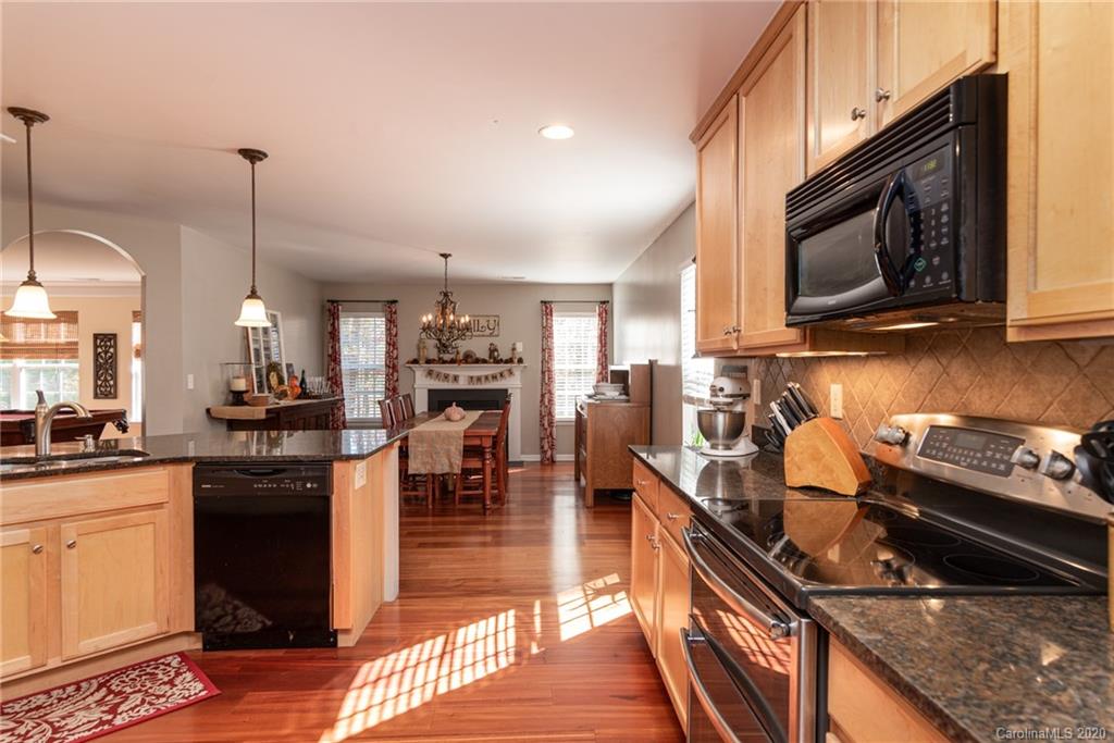 7838 East Berkeley Road Denver, NC 28037 - Photo 11 of 34 a kitchen with stainless steel appliances granite countertop a stove a sink and a microwave