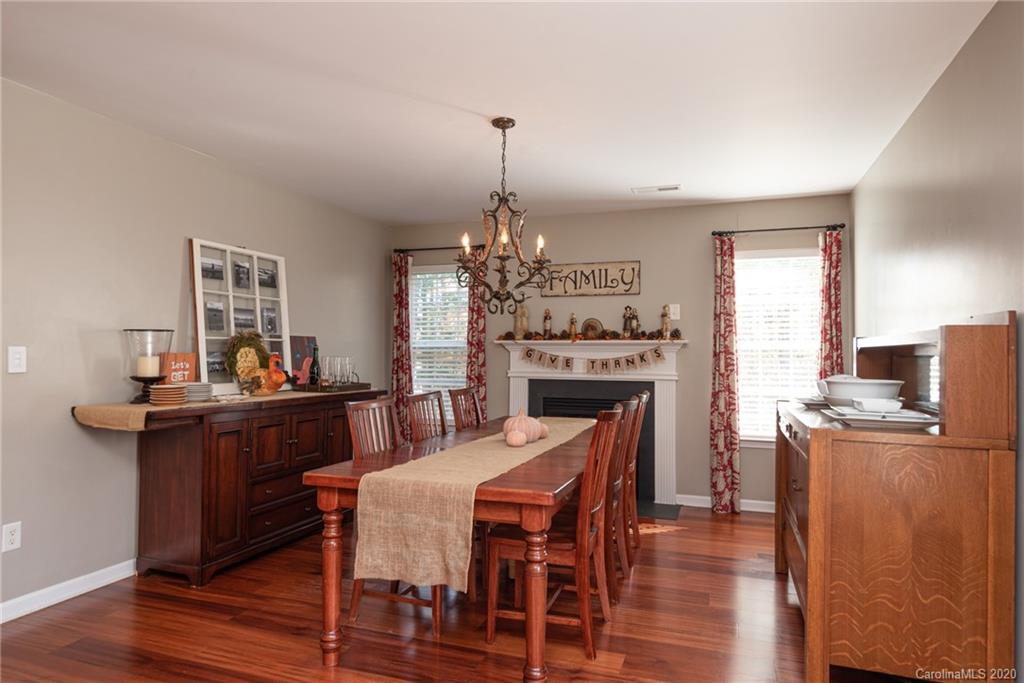 7838 East Berkeley Road Denver, NC 28037 - Photo 12 of 34 a dining room with furniture a chandelier and wooden floor