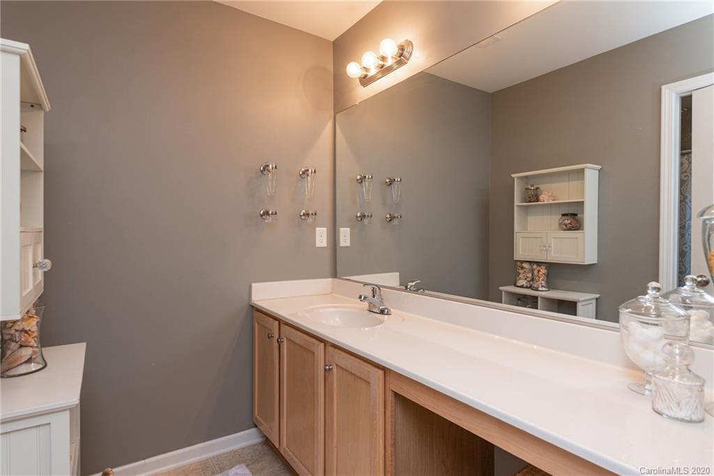 7838 East Berkeley Road Denver, NC 28037 - Photo 17 of 34 a bathroom with a sink vanity and a mirror