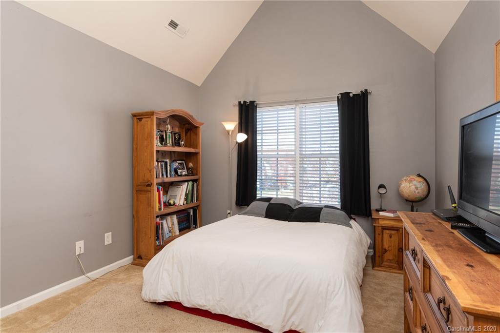 7838 East Berkeley Road Denver, NC 28037 - Photo 20 of 34 a bedroom with a bed and a book shelf