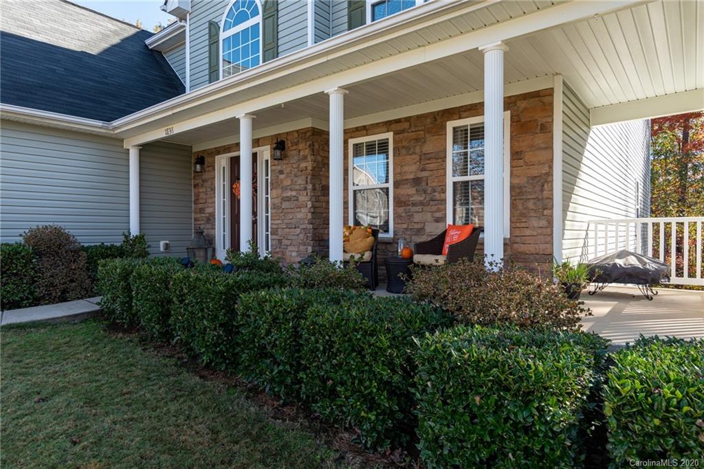 7838 East Berkeley Road Denver, NC 28037 - Photo 3 of 34 a view of a house with potted plants and a table and chairs