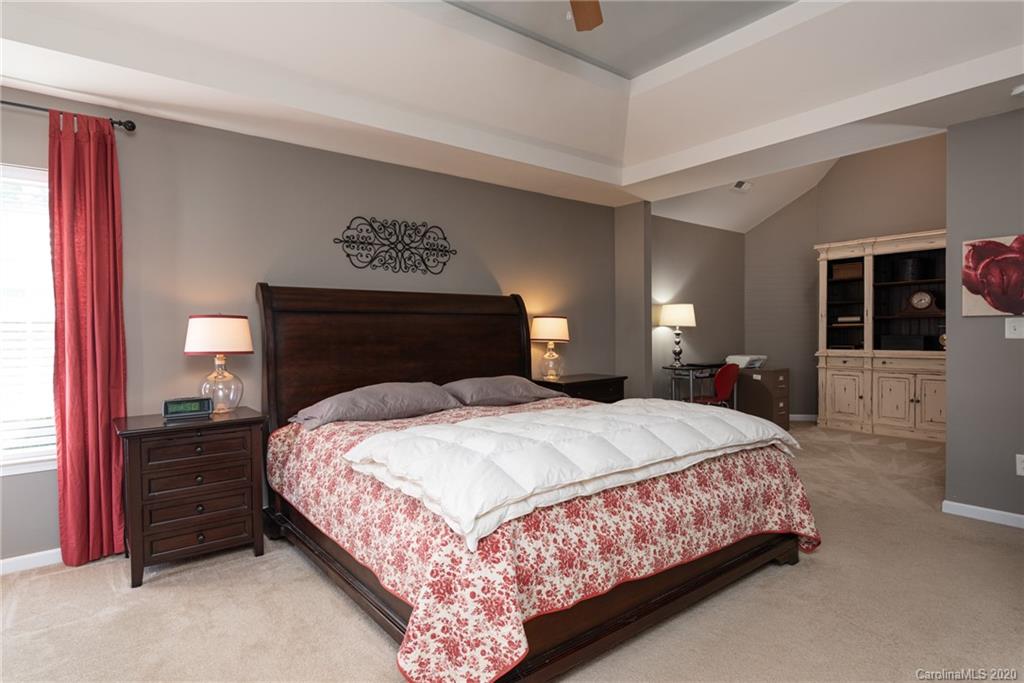 7838 East Berkeley Road Denver, NC 28037 - Photo 22 of 34 a bedroom with a bed and a large mirror on dresser