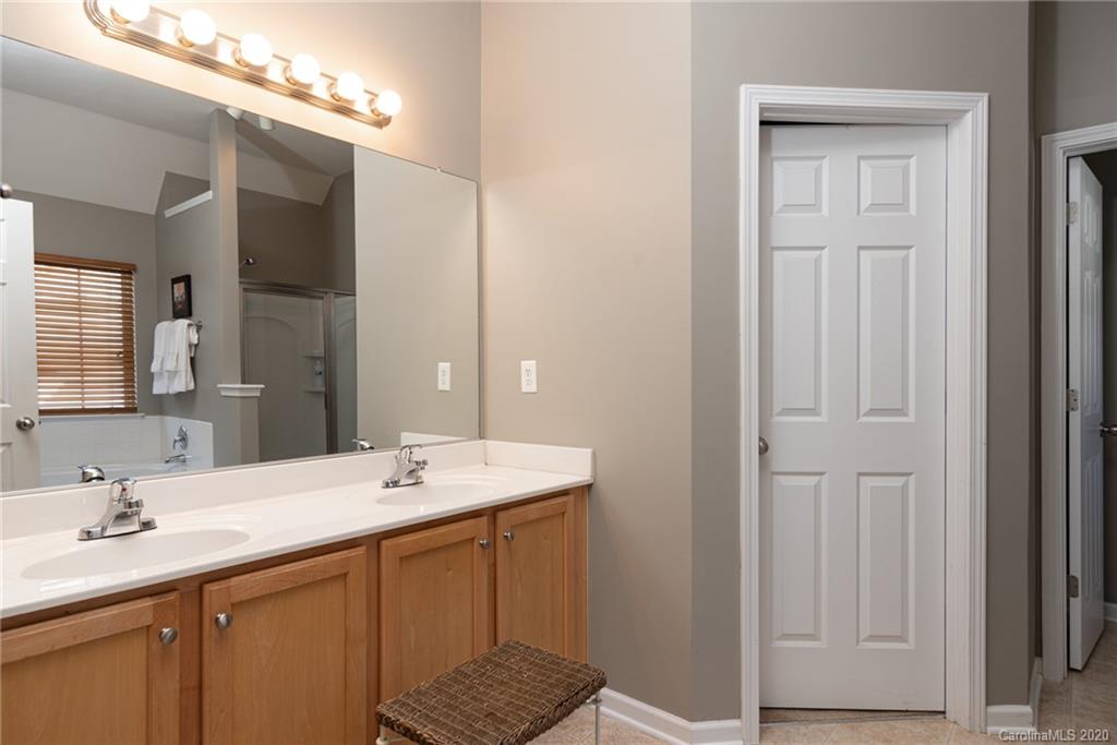 7838 East Berkeley Road Denver, NC 28037 - Photo 23 of 34 a bathroom with a double vanity sink and a mirror