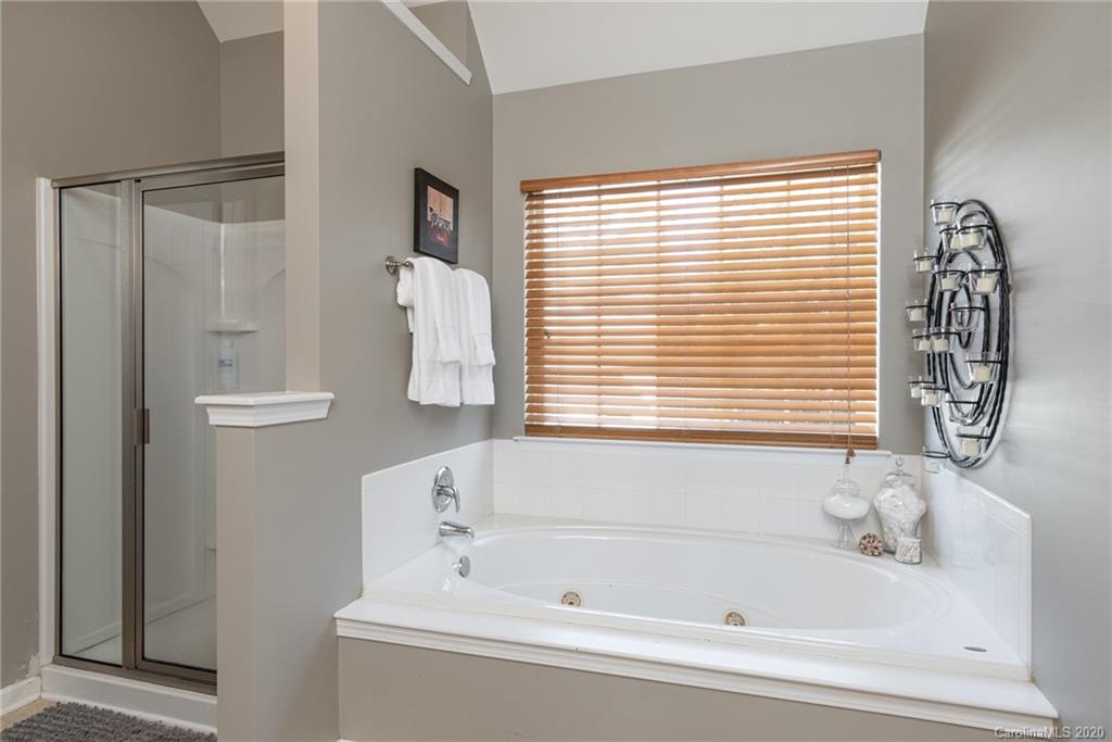7838 East Berkeley Road Denver, NC 28037 - Photo 24 of 34 a bathroom with a bathtub and a shower