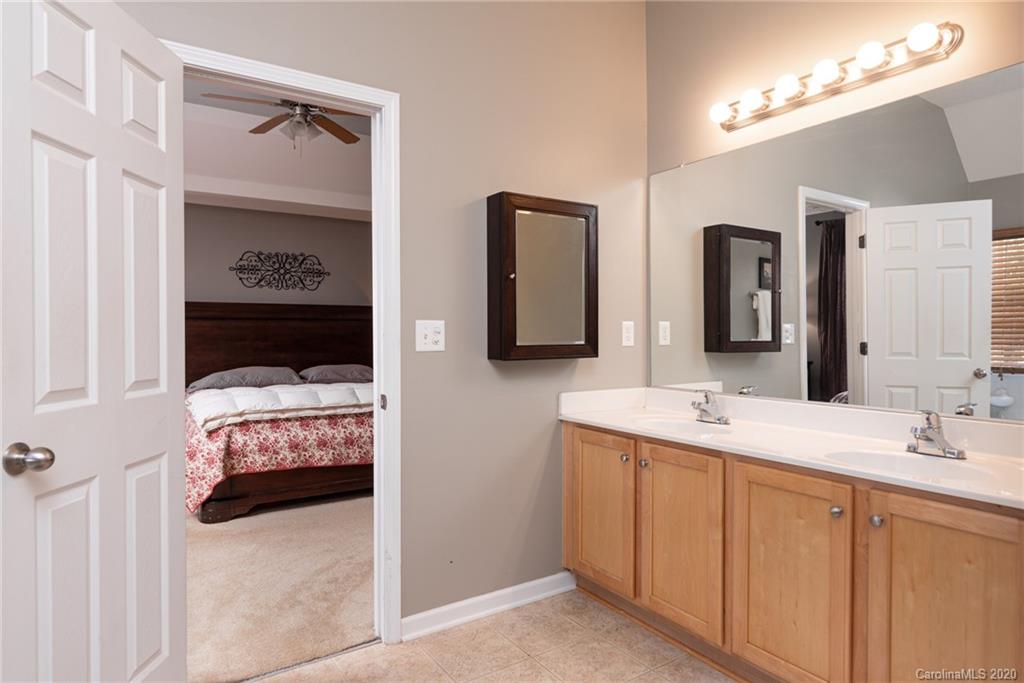 7838 East Berkeley Road Denver, NC 28037 - Photo 25 of 34 a en suite bathroom with double vanity and a mirror