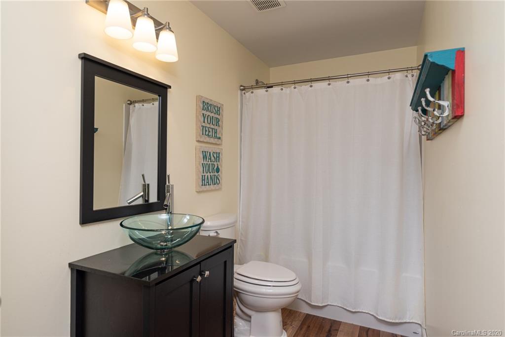 7838 East Berkeley Road Denver, NC 28037 - Photo 27 of 34 a bathroom with a granite countertop sink toilet and mirror