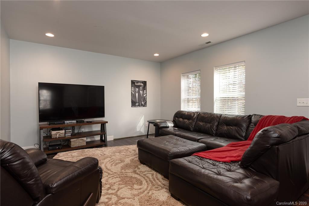 7838 East Berkeley Road Denver, NC 28037 - Photo 29 of 34 a living room with furniture and a flat screen tv
