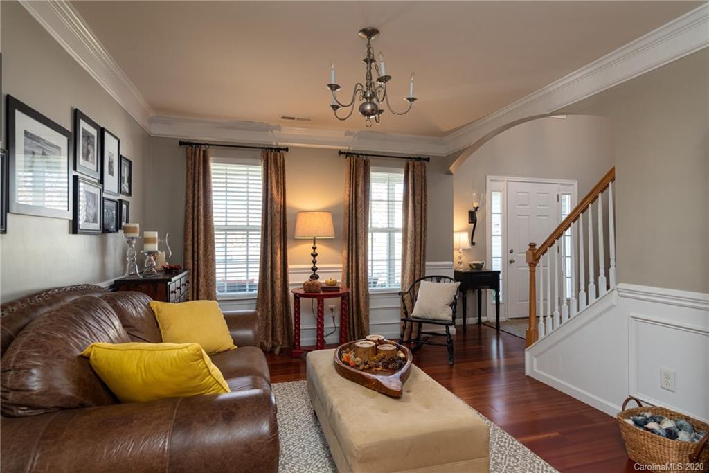7838 East Berkeley Road Denver, NC 28037 - Photo 6 of 34 a living room with furniture and a chandelier