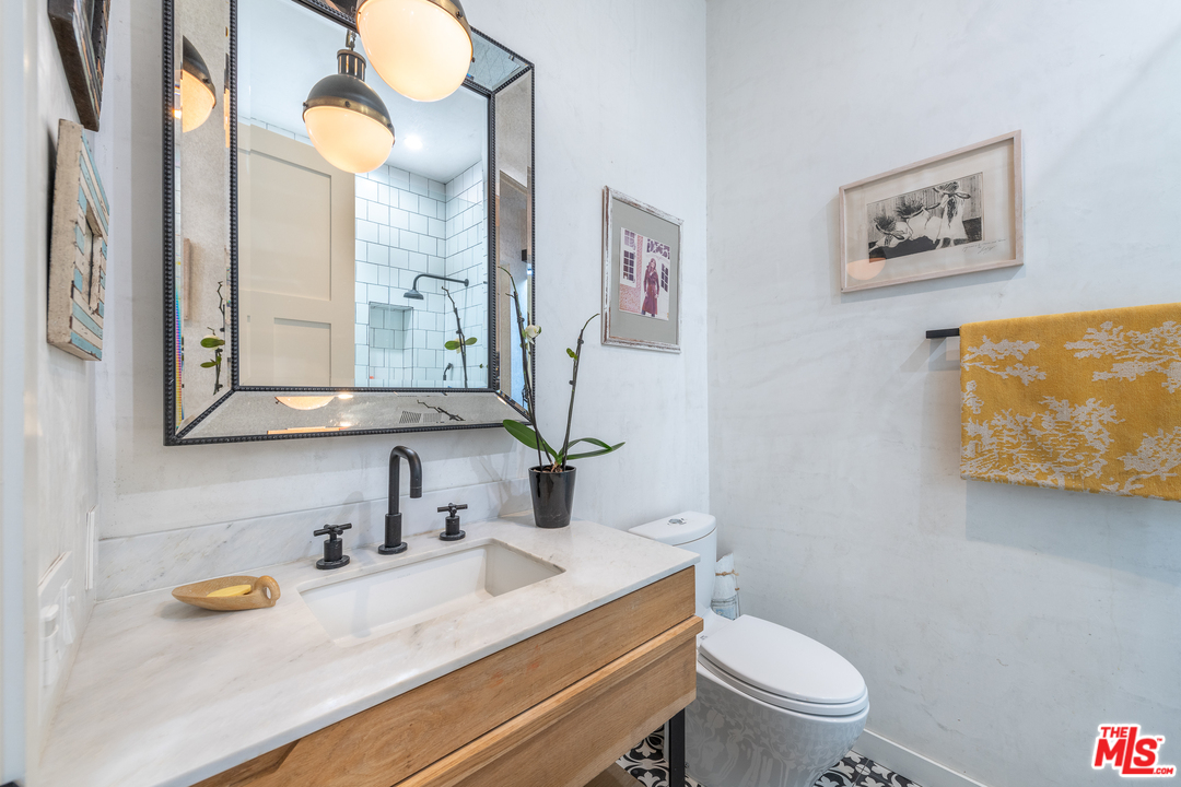 910 Dickson Street Marina del Rey, CA 90292 - Photo 25 of 52 a bathroom with a granite countertop sink mirror vanity and toilet