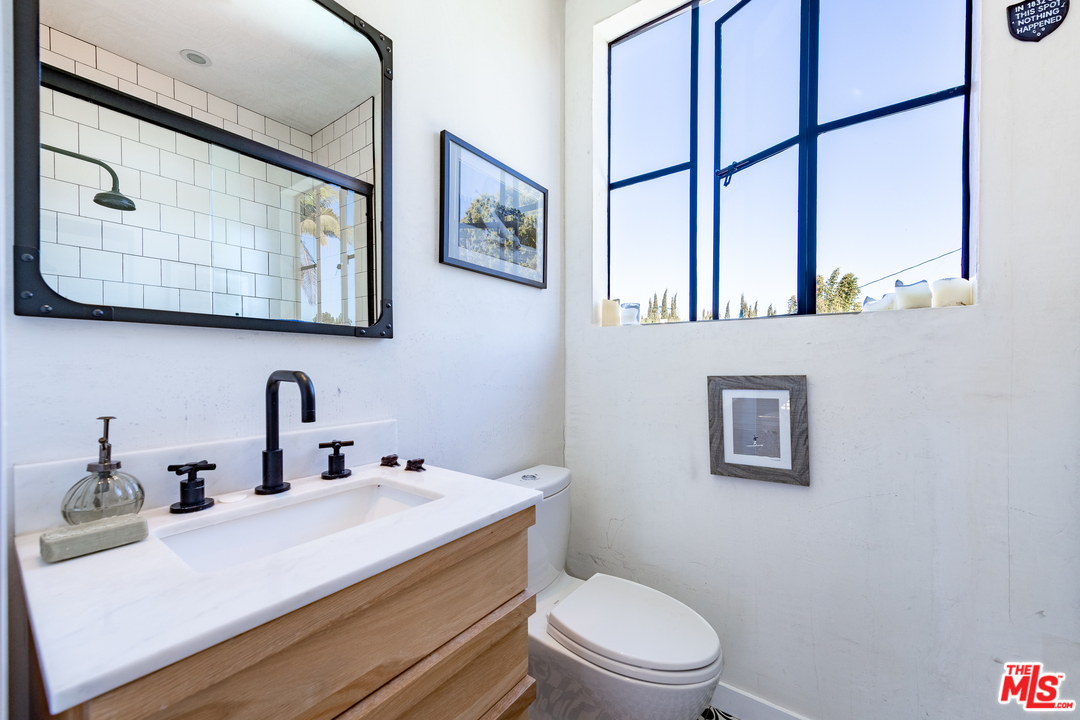 910 Dickson Street Marina del Rey, CA 90292 - Photo 48 of 52 a bathroom with a toilet sink and mirror