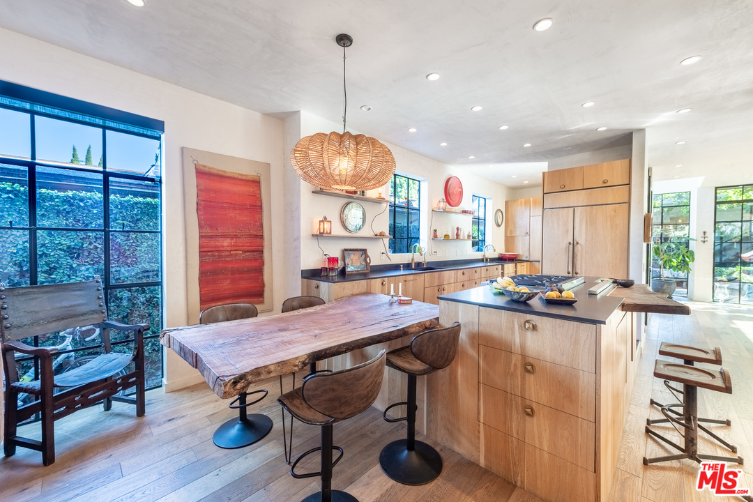 910 Dickson Street Marina del Rey, CA 90292 - Photo 10 of 52 a kitchen with stainless steel appliances granite countertop a stove a sink dishwasher a dining table and chairs with wooden floor