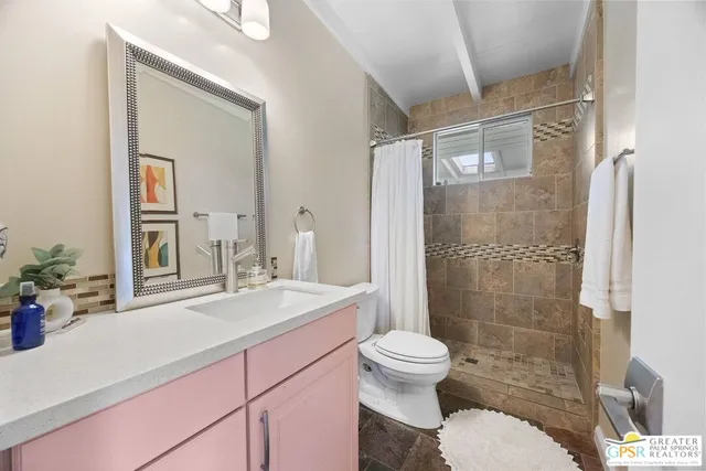 a bathroom with a sink toilet and shower